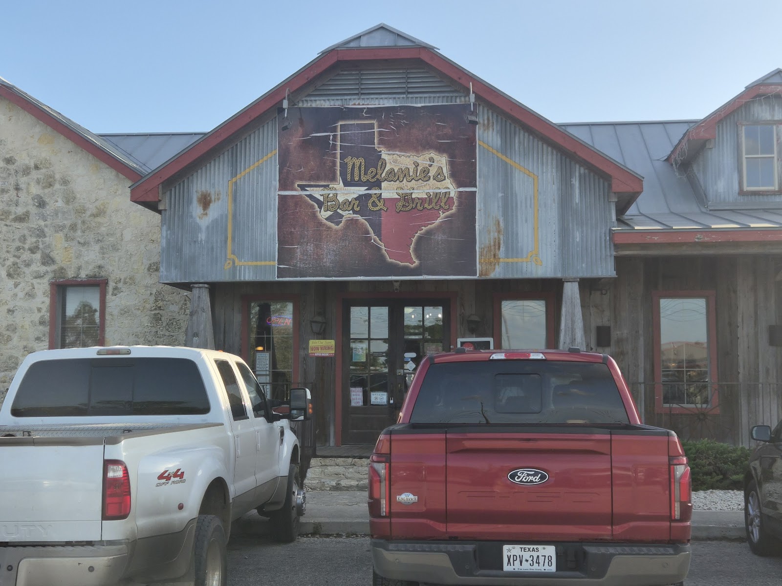 Melanie's Bar & Grill exterior with rustic barn-style building