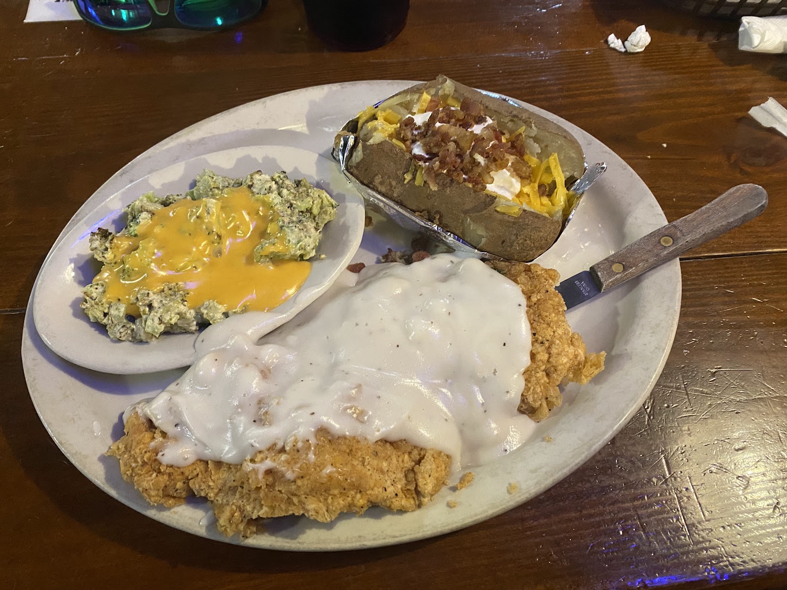 Chicken fried steak with cream gravy and loaded baked potato