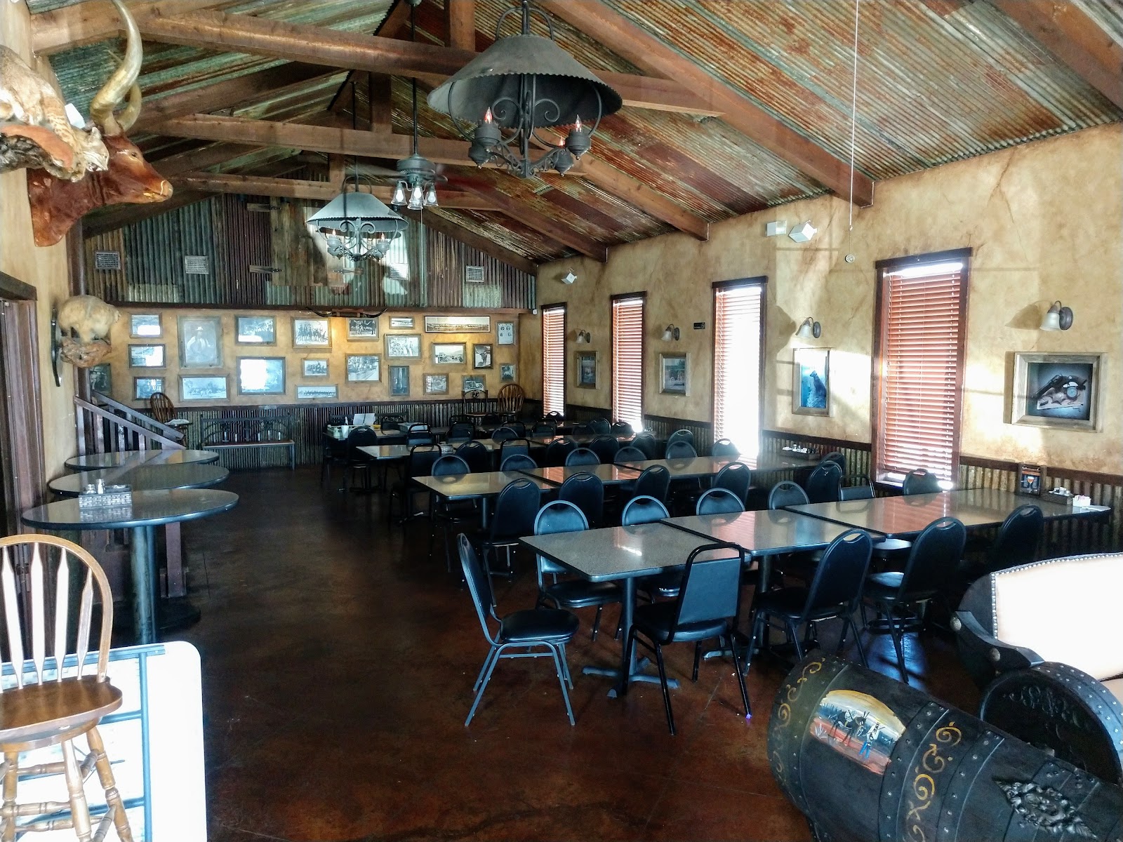 Rustic dining room at Melanie's Bar & Grill with longhorn mount and ranch photos